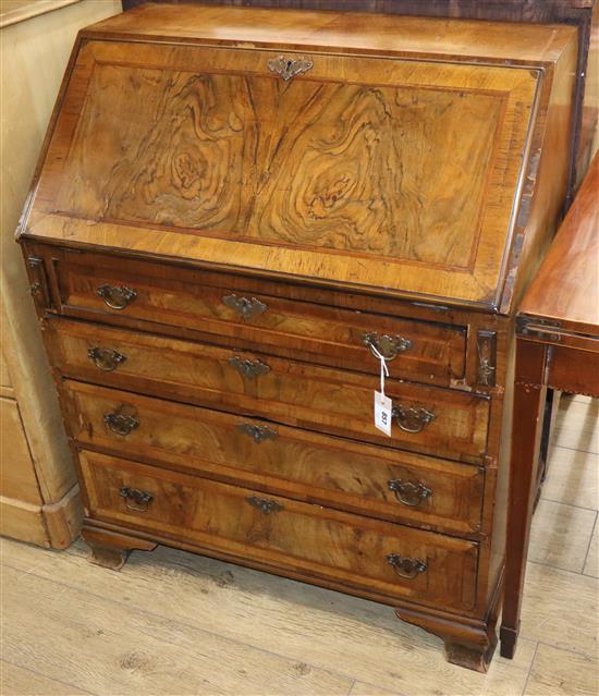 A George III style figured walnut bureau W.81cm